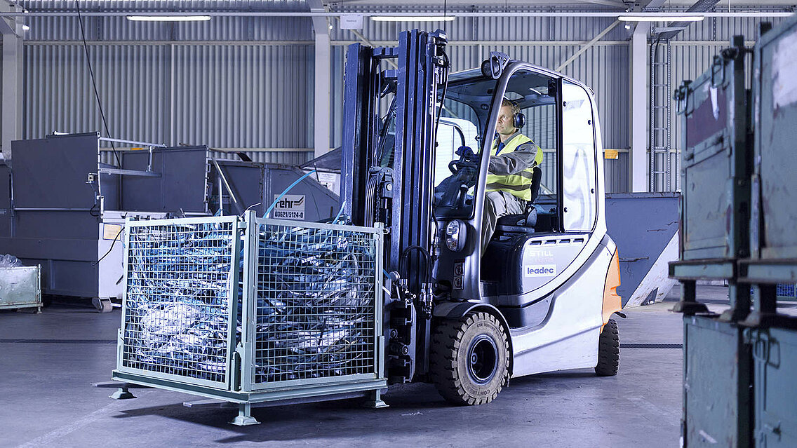 Ein Leadec-Mitarbeiter transportiert mit einem Gabelstapler eine Palette mit Abfall durch die Fabrik.