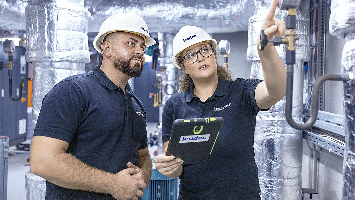 Two Leadec employees inspecting thermal power station.